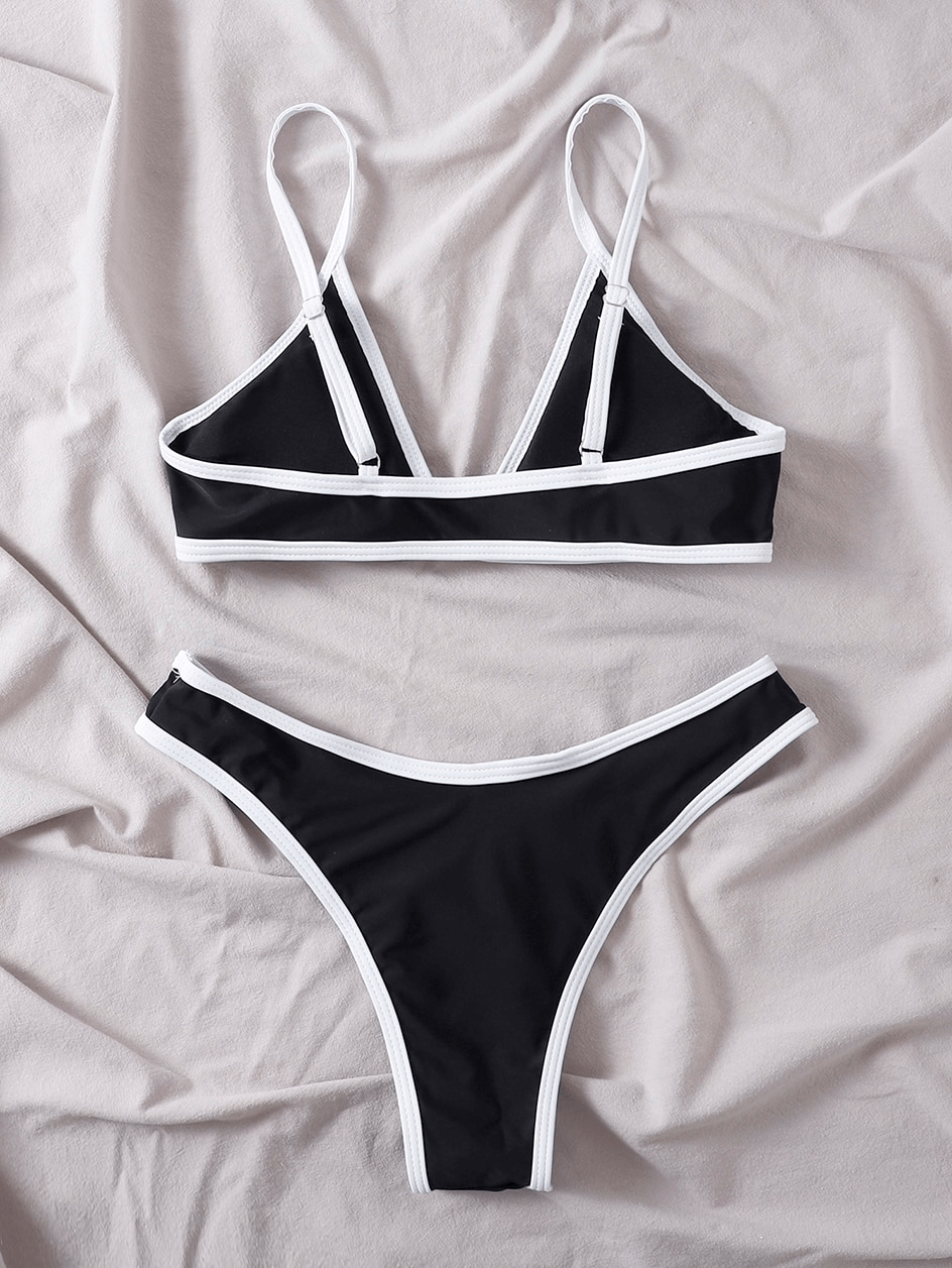 Sleek black and white micro bikini set with adjustable straps, perfect for women seeking a stylish and comfortable beachwear option.